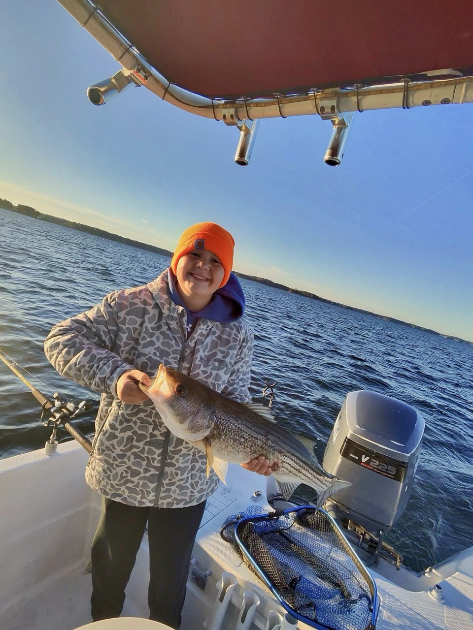 Lake Lanier Striper Fishing Report – October 19, 2026 Young angler with a striped bass on Lake Lanier