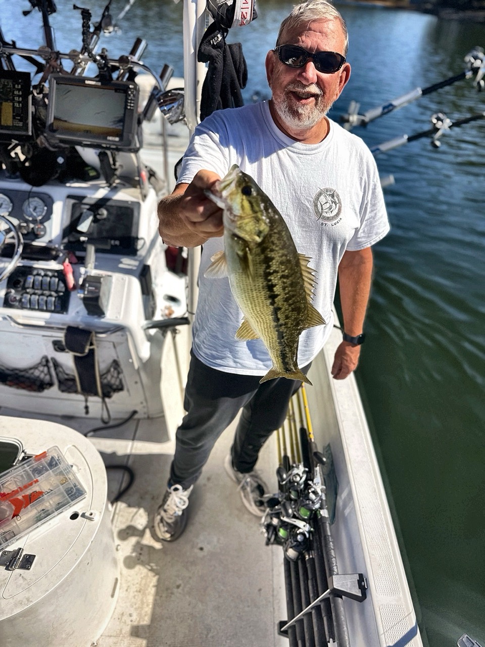 Lake Lanier Striper Fishing Report – October 22, 2026 Angler holding a spotted bass beside the electronics aboard Lake Lanier Striper Snipers