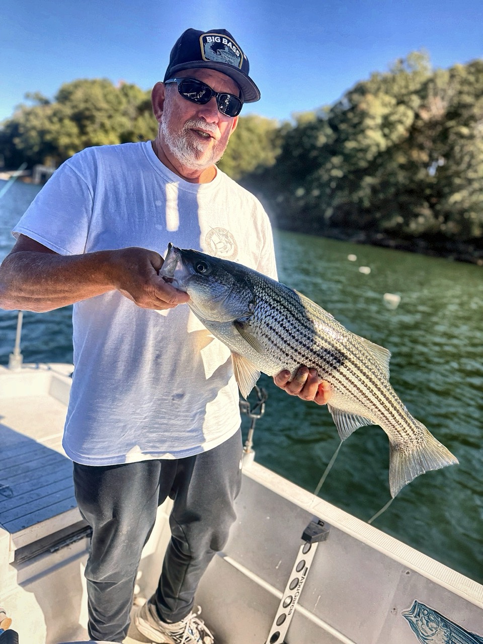 Lake Lanier Striper Fishing Report – October 22, 2026 Angler holding a striped bass caught around 30 feet deep on Lake Lanier