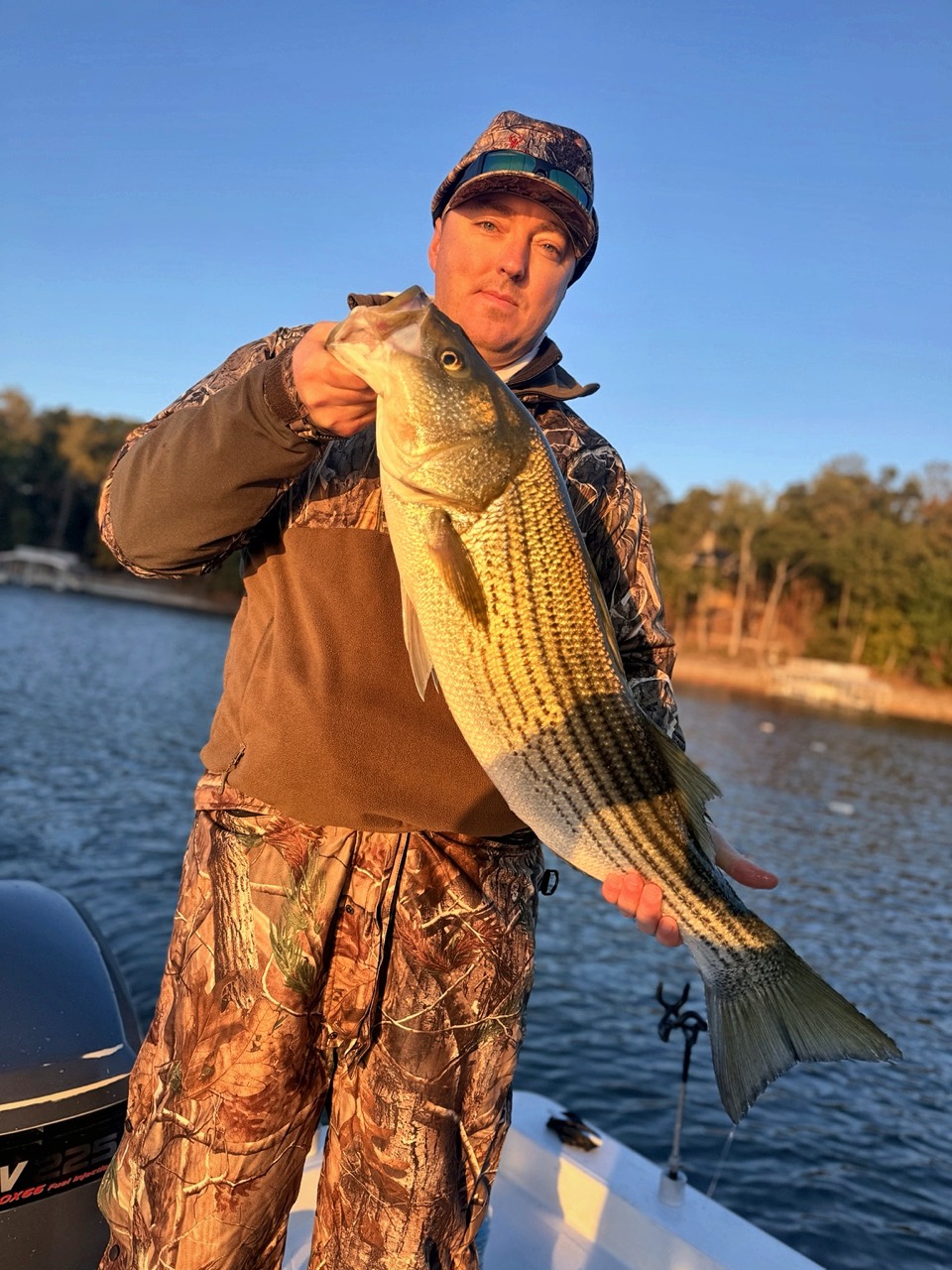 Lake Lanier Striper Fishing Report – October 24, 2026 | Tough Conditions, Quality Fish & Fall Migration Angler holding a quality striped bass during the Lake Lanier fall migration