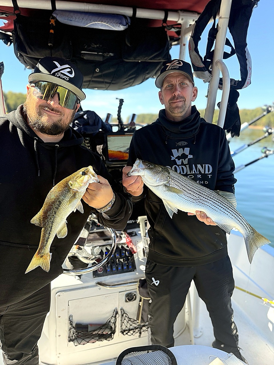 Lake Lanier Striper Fishing Report – October 20, 2026 Two anglers displaying a spotted bass and striped bass on Lake Lanier