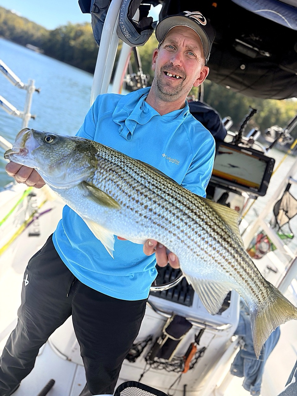 Lake Lanier Striper Fishing Report – October 20, 2026 Angler holding a personal-best striped bass on Lake Lanier